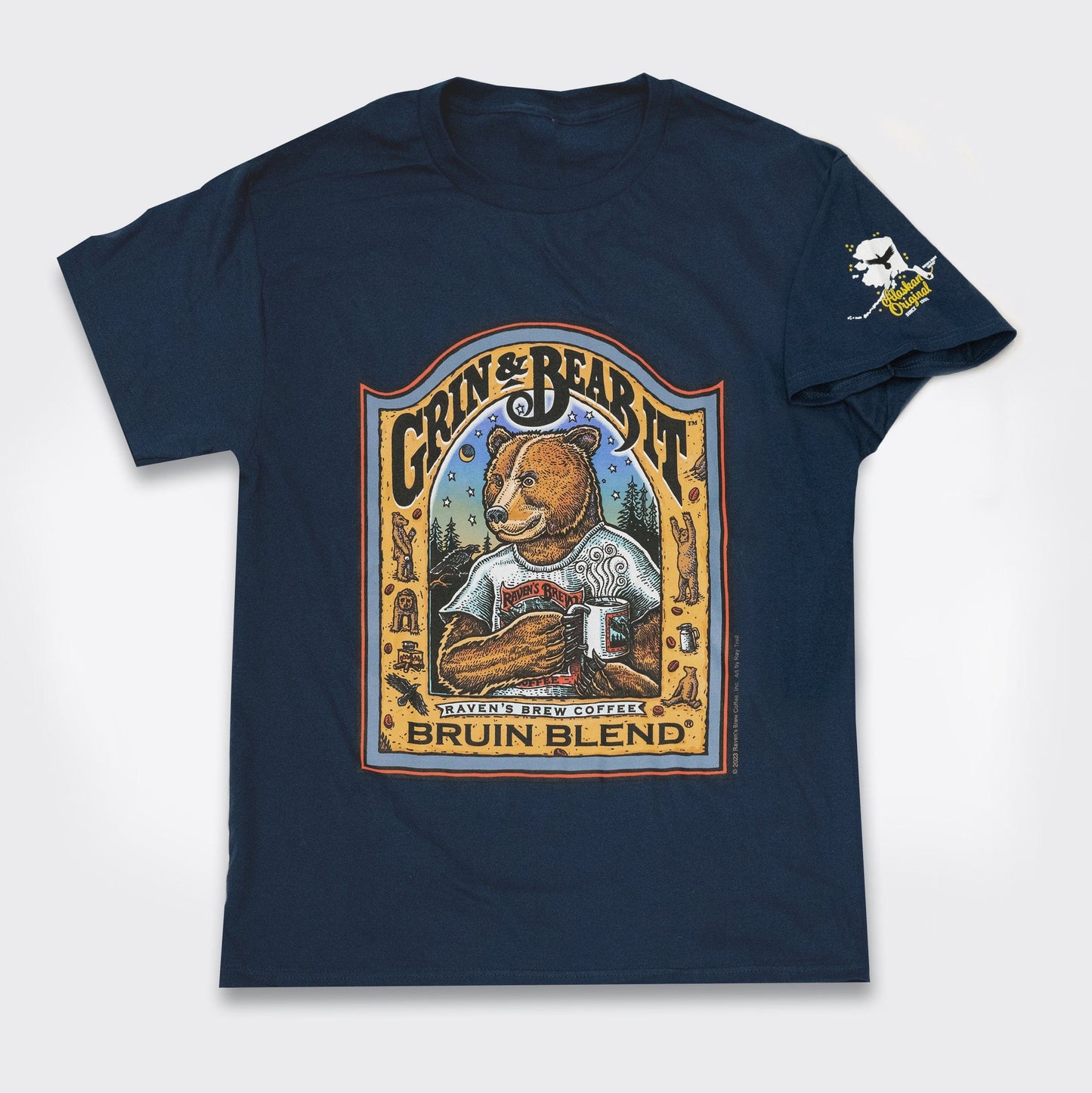 Bruin Blend® Bear drinking coffee illustration on a navy tshirt with illustration on sleeve showing Alaska and the words "Alaskan Original"