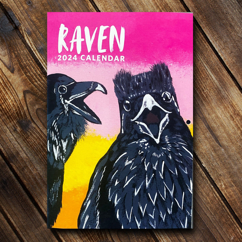 2024 12-Month Raven Calendar: cover pictured features two cawing ravens on a bring pink to yellow gradient background.