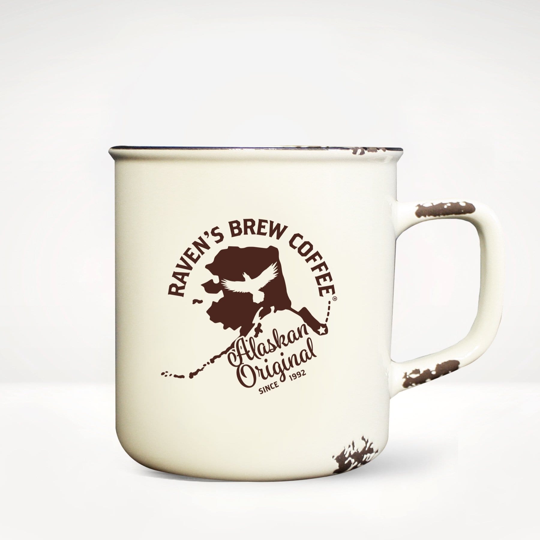 Alaskan Original Camp Mug front view featuring Alaska State shape, Raven's Brew Coffee Logo, and the words Alaskan Original Since 1992.