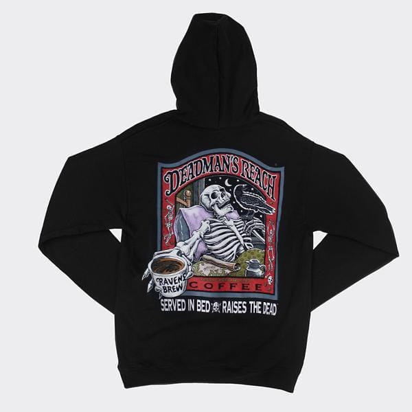 Deadman’s Reach® Coffee Label Pullover Hoody in black featuring a skeleton reclined in bed, extending a steaming cup of Raven’s Brew coffee outwards towards the viewer. A black raven sits perched on a finger on his other hand Deadmans Reach® Coffee.